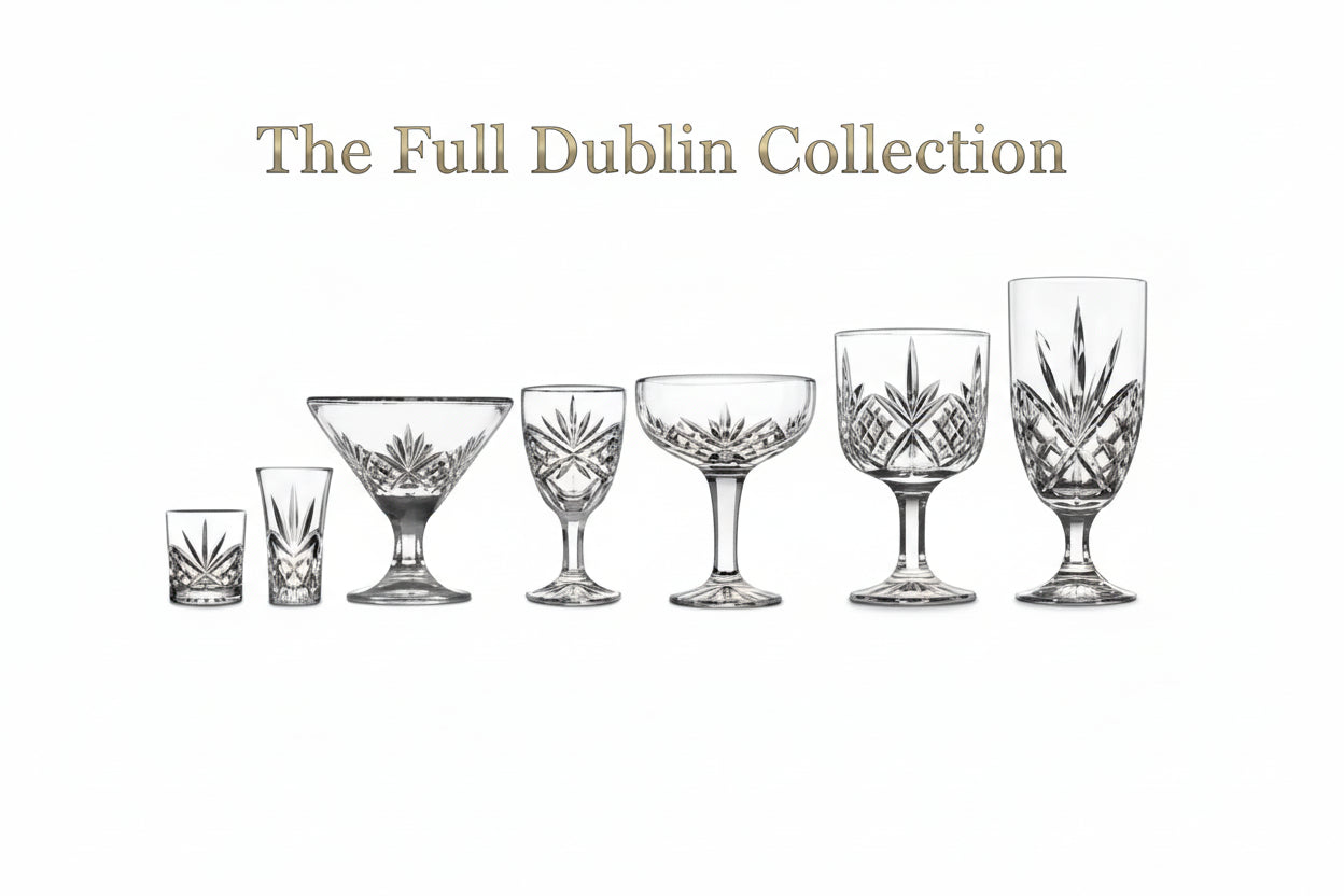 Set of six crystal glasses of different shapes and sizes on a white background